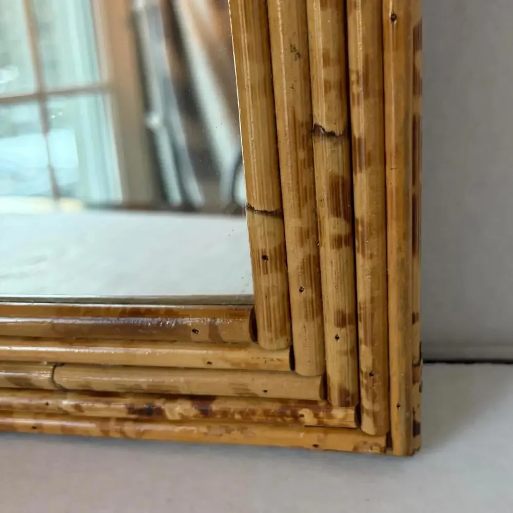 Vintage Arched rattan mirror with a natural, aged finish.
